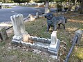 Cast-iron dog statue overlooking child's grave