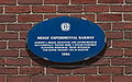 Plaque marking the site on the side of the former Genoa Packing Co. building.
