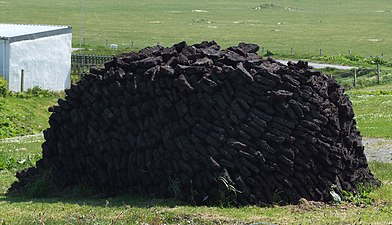 A stack of peat cut from the Earth in the Outer Hebrides, Scotland. Peat is partially decayed vegetative matter