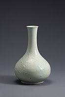 White Porcelain Bottle with Plum and Bird Design in Relief