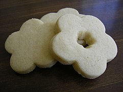 Undecorated sugar cookies, rolled out and cut into the shape of a flower