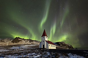 Green aurora over the Víkurkirkja church at Vík in Iceland
