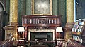 Fireplace in the current Smoking Room, National Liberal Club, note wooden mantle enclosing marble fire-surround, with dark tiles within the fireplace