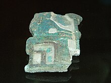 Fragmentary relief of green glaze showing a woman seated