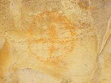 A pictograph of an orange circle with a cross through it.
