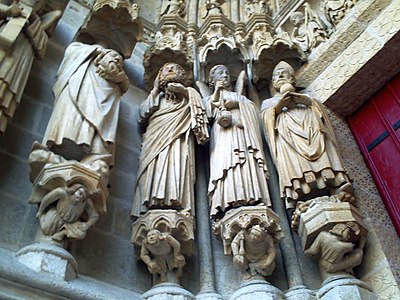 Local saints including the decapitated martyrs, Victoricus and Gentian, in the west portals