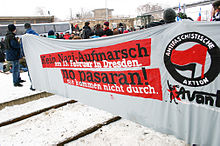 Protesters holding a large anti-fascist banner