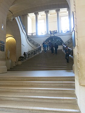 Long view showing its location on the Mollien Stairs of the Louvre
