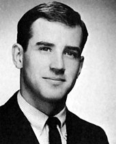 Black-and-white head and shoulders studio portrait of Biden in a suit and tie, looking past the camera to the right