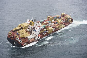 Grounded container ship, the MV Rena off New Zealand, 5 October 2011. Some of the bottom containers collapsed, but many twistlocks held, resulting in the cargo stacks falling over.