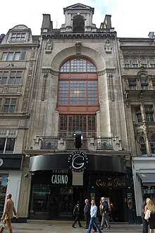 Front of the Cafe de Paris – a six storey building, dominated by a glass frontage in the upper storeys.