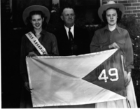 Dorothy Fellows, Miss Absaroka (left), A. R. Swickard (middle), and Esther Aspaas (right), holding the proposed Absaroka state flag.