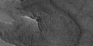 Close-up of East side (right side) of previous image of pedestal crater showing polygons on lobe. Since the margin of the crater has lobes and polygons, it is believed there is ice under the protective top. Picture taken with HiRISE under HiWish program. Note: this is an enlargement of the previous image.