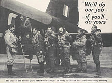 Black and white photo of seven RAF crew standing beside place