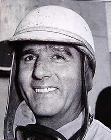 black and white photo of Nino Farina wearing an open-faced helmet
