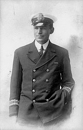 Man in dark naval uniform and wearing an officer's cap