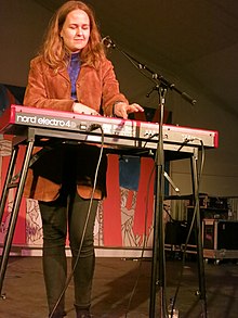 Alice Boman singing and playing a keyboard