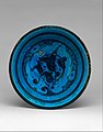 A bowl, late 15th century, black paint under turquoise glaze, incised.