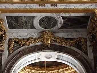 Baroque festoon with a mascaron in the Hall of Mirrors of the Palace of Versailles, Versailles, France, designed by Jules Hardouin-Mansart, 1678-1684[8]