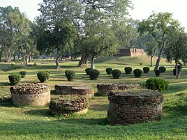 Scene in Jetavana, showing some small stupas.