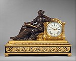 Neoclassical mantel clock (pendule de cheminée); 1757–1760; gilded (ormolu) and patinated bronze, oak veneered with ebony, white enamel with black numerals, and other materials; 48.3 × 69.9 × 27.9 cm; Metropolitan Museum of Art