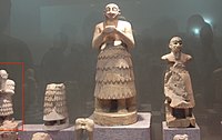 Statues from Mari. The statue of Ishqi-Mari appears partially on the left: it is much smaller than many of the traditional Mari statues.[1] Aleppo National Museum