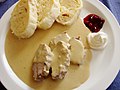 Image 2Svíčková na smetaně served with dumplings, whipped cream and cranberries (from Czech cuisine)