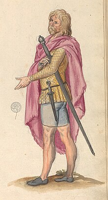 Man in belted yellow checkered tunic, black shoes, blue shorts, and light-red cloak, with sword and dirk.
