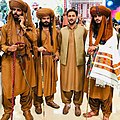 A group of Baloch men wearing traditional dress, including Balochi shalwar kameez