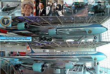 A metal-trussed hangar with a glass front and a shiny floor holds a large jet emblazoned with "United States of America" and other artifacts.