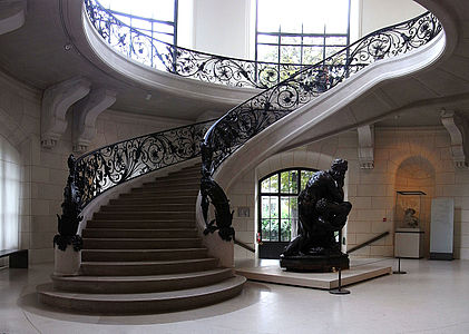 The interior of the Petit Palais, with a curving stairway built of reinforced concrete and iron.
