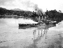 USS Missouri in Gatun Lake, smoke is coming out of the three smokestacks in the center of the vessel
