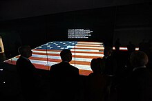 Image of the Star-spangled-banner flag in the National Museum of American History, being observed By George W. bush
