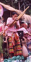 Khaen player in a sarong and pakama.