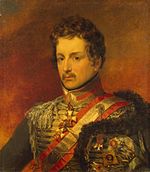 Painting shows a serious-looking young man with a mustache and wavy hair. He wears an elaborate hussar military uniform with gold lace and a gold and red sash over his shoulder.