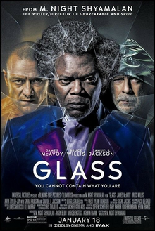 Behind a shattered glass stands the three protagonists of the film; on the left is Kevin Wendell Crumb / The Horde, on the right is David Dunn / The Overseer, and in the center is Elijah Price / Mr. Glass.