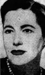 Newspaper headshot of a white women with pale skin and dark hair. Her lipstick is also dark.