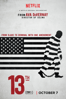The poster shows an American flag in black and white with a black-cameo of a man in black and white-stripped uniform with chains shackled to its ankles. On top of the flag, text reads "FROM SLAVE TO CRIMINAL WITH ONE AMENDEMENT."