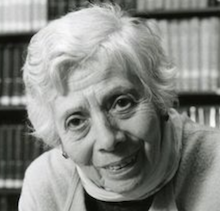 headshot of an older white woman in short hair tilting her head and looking directly into the camera