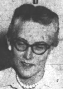 Newspaper photograph of a middle-aged white woman wearing cat-eye glasses