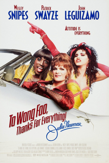 Three drag queens ride in an open-top car.
