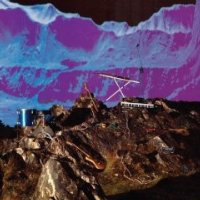 Album cover collage with an artistic blue mountain range in the background and a brown/grey rocky landscape containing a guitar, a drum, two keyboards, and lengths of electrical wire in the foreground.