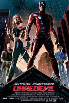 A man in red mask and red leather suit stands at a rooftop corner, in the rain. A woman stands near him with two forked weapons. In the background stands a bald white man in a long leather jacket, and a bald black man in a white business suit.