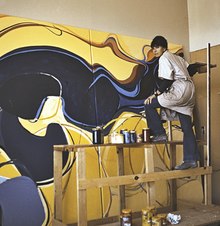 Rita Deanin Abbey working on her mural Bridge Mountain