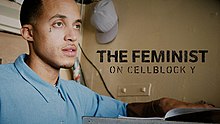 On the title card for the film, the profile of Richie Reseda's face looks in the distance. He has light skin, short hair, a goatee, and a small tattoo below his right eye. The Feminist on Cellblock Y is printed in a thick black text next to his face.