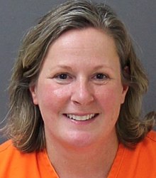 Kimberly Potter's booking photo, with Potter smiling, looking at the camera