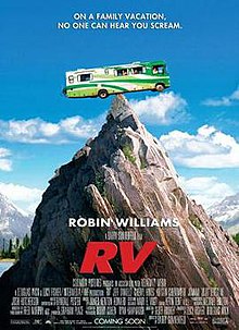 A green Recreational vehicle (RV) perched precariously on a mountain peak.