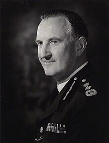 Sir Arthur Young, head-length portrait photograph looking left with moustache, in police uniform