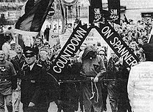 Image shows a parade through Central London, led by a banner reading 'Countdown on Spanner'