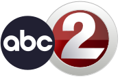 A logo with two different circular elements; a black ABC logo, then the station's main numerical logo, which features a numerical gray-gradient "2" inset into a thick circle of the same color. A contrasting dark red gradient fills in the space between the circle and the "2"